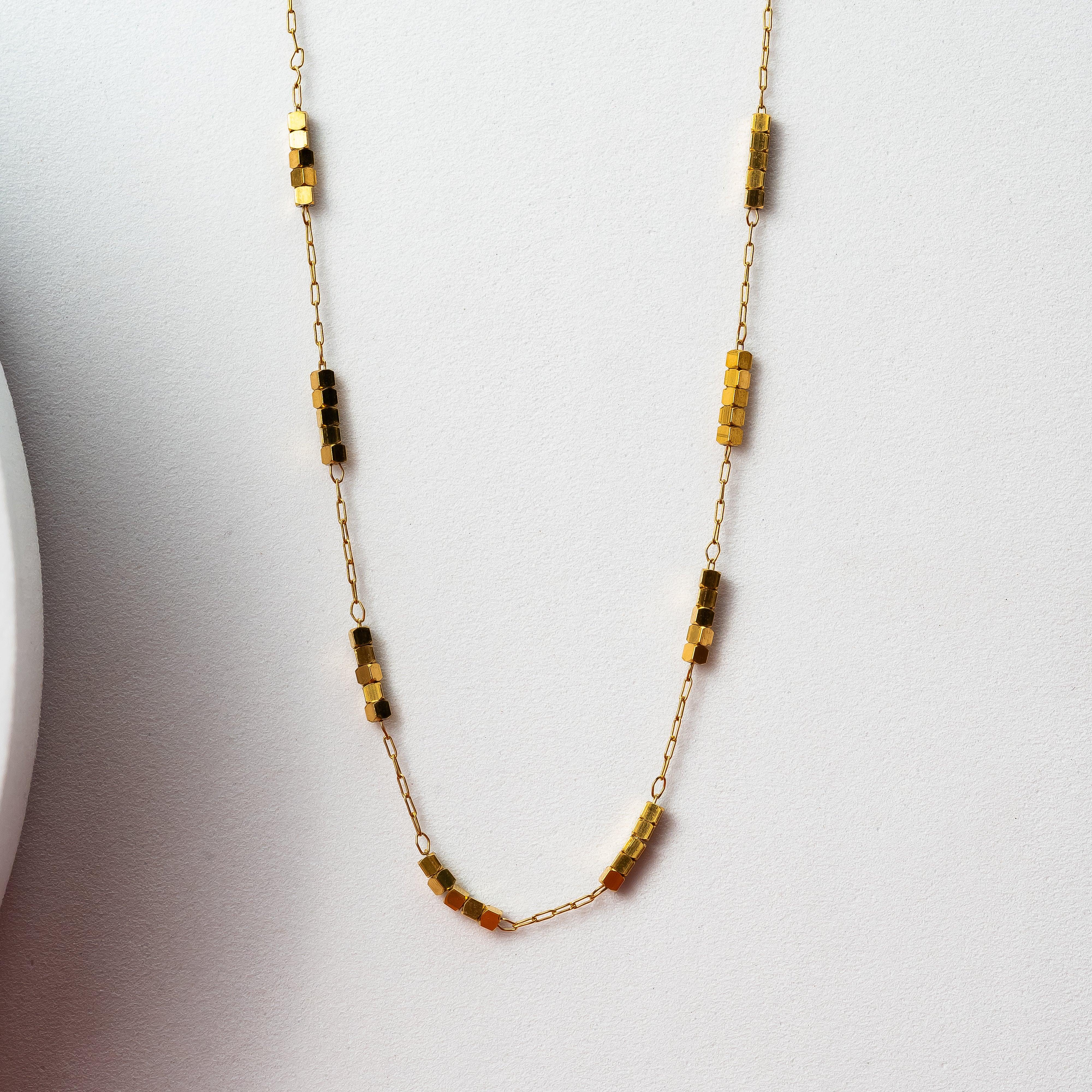 Golden chain with metal charm