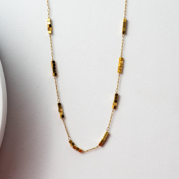 Golden chain with metal charm